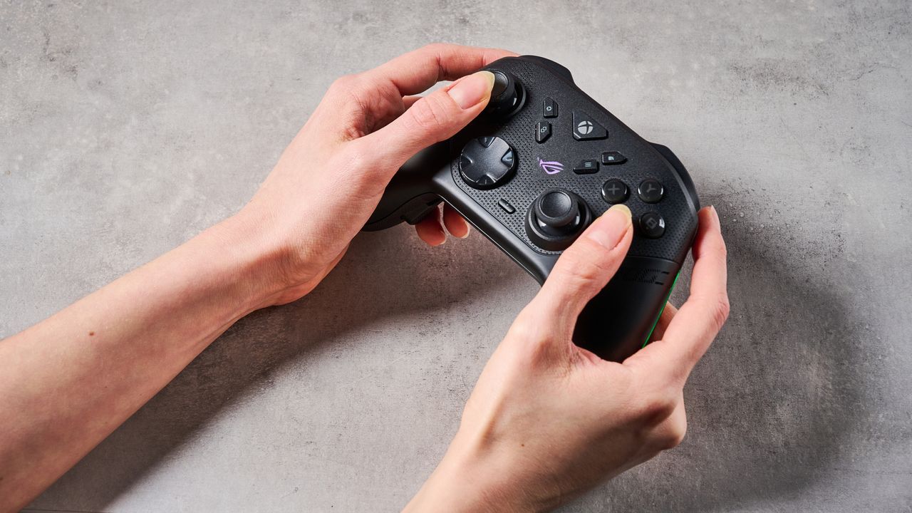 A woman's hands holding the Asus ROG Raikiri II Xbox Wireless above a stone-effect surface.