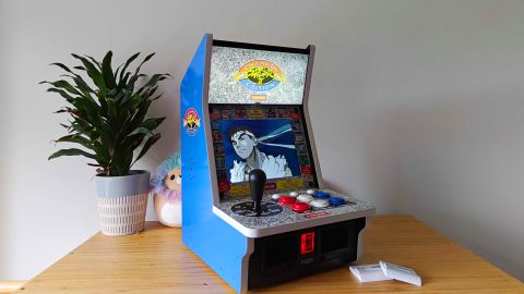 Side view of Evercade Alpha with Ryu from Street Fighter Alpha 3 on screen