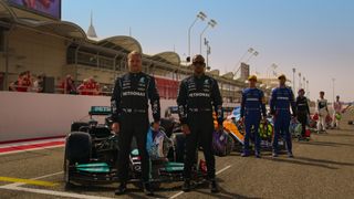 Mercedes drivers Valtteri Bottas (left) and Lewis Hamilton pose in front of some of the other F1 teams for 'Formula 1: Drive to Survive' season 4.