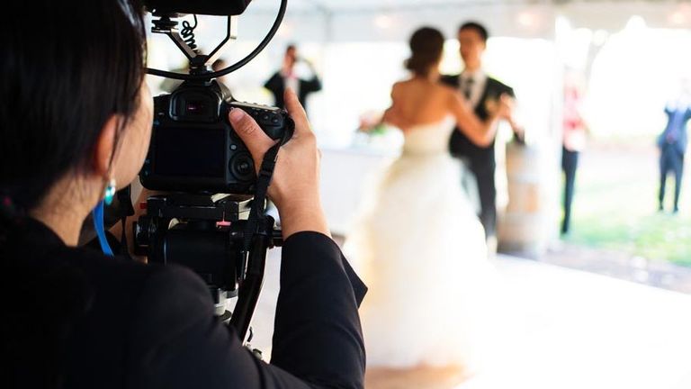 Dress, Video camera, Camera, Photograph, Bridal clothing, Cameras & optics, Television crew, Camera operator, Videographer, Strapless dress, 