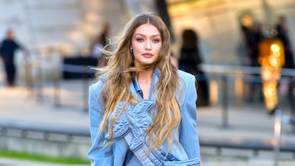 us model gigi hadid presents a creation for fashion house versace during the presentation of its womens and mens springsummer 2020 fashion collection in milan on june 15, 2019 photo by miguel medina afp photo credit should read miguel medinaafp via getty images