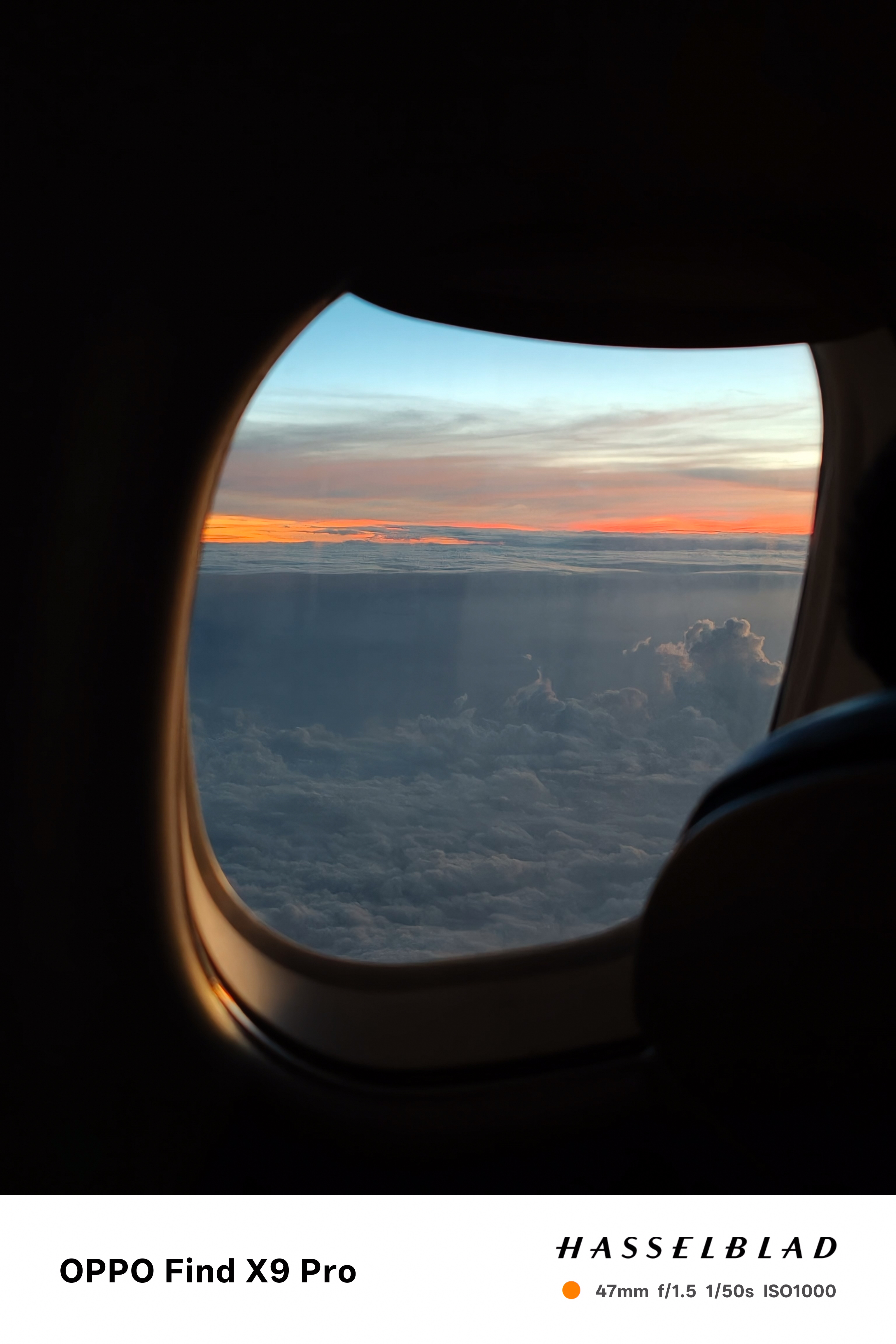 View of a sunset above clouds out of an aeroplane window