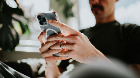 Mans hand holding a mobile phone. Conceptual with space for copy.