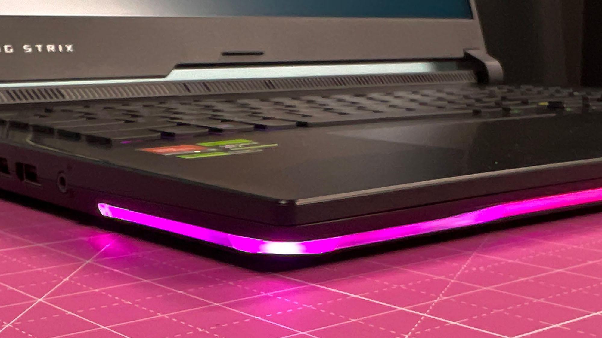 An Asus ROG Strix Scar 17 (2023) on a desk with a pink desk mat