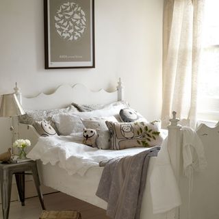 white bedroom with bed and lamp