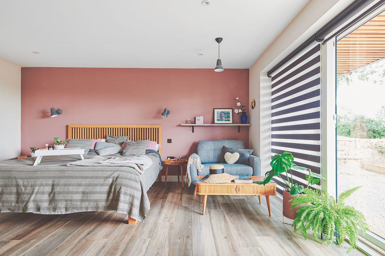 pink bedroom in self build with large windows