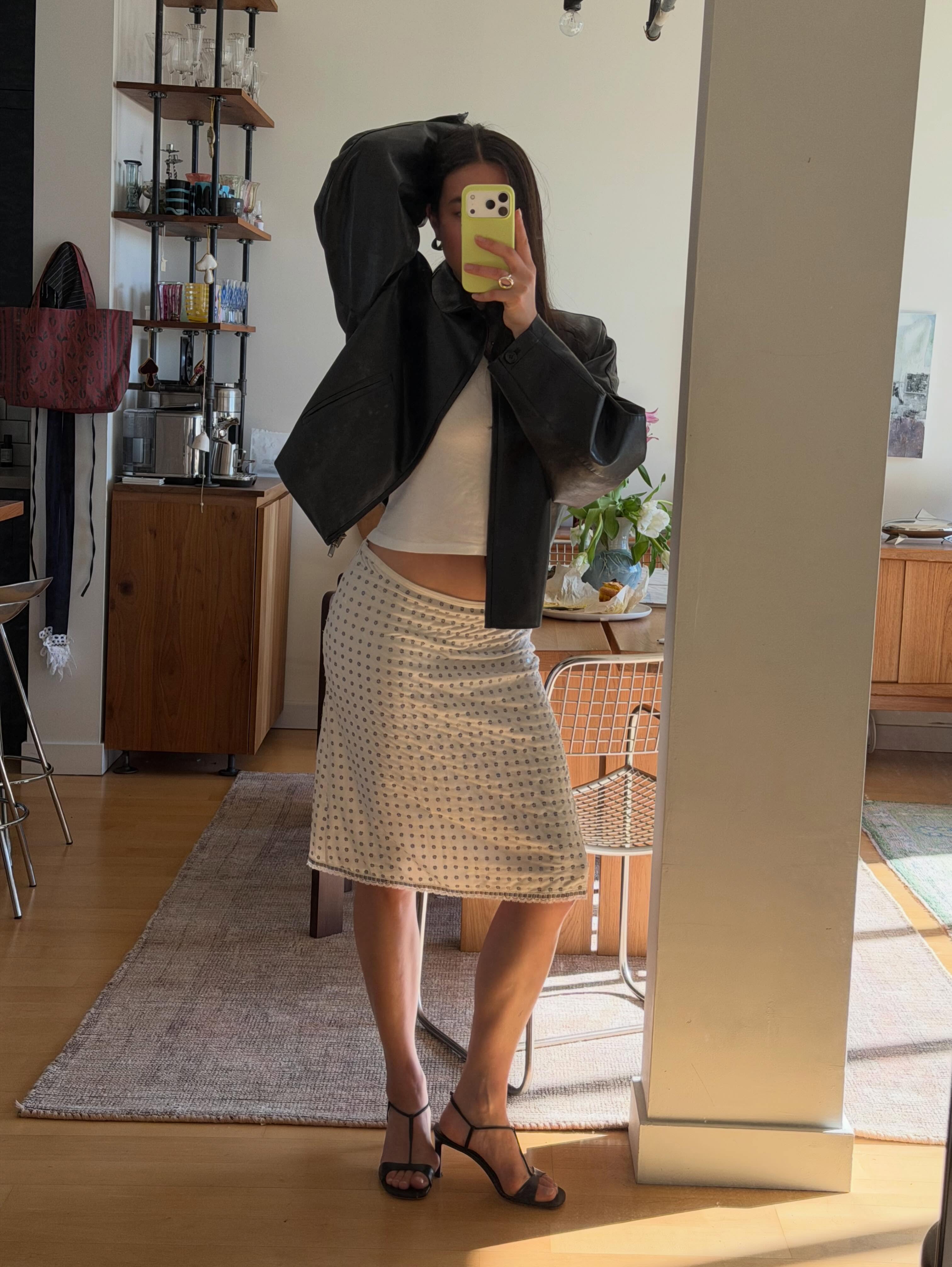 An image of a woman wearing summer knee length skirt outfit 2026