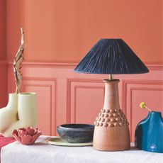Pink and orange wall with blue accent accessories