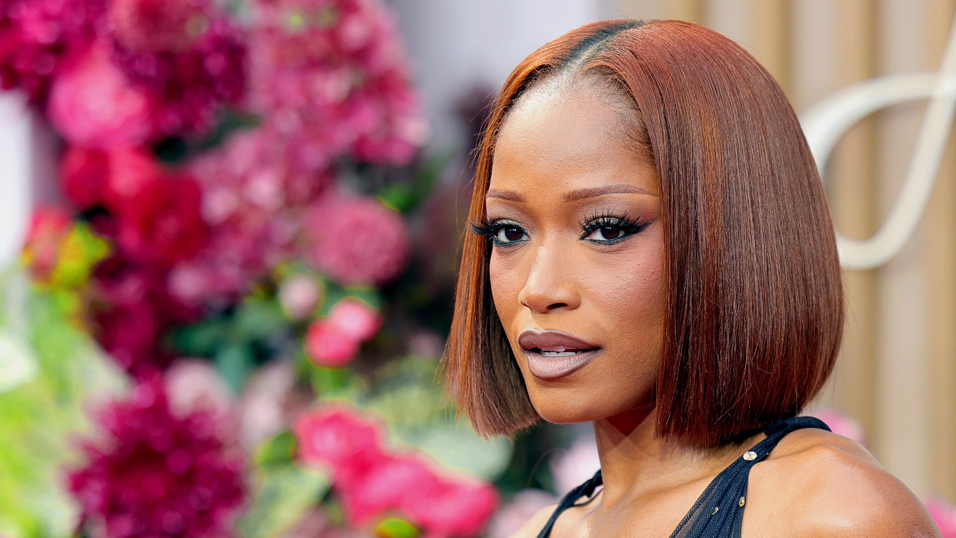 a black woman with red, bob-length hair