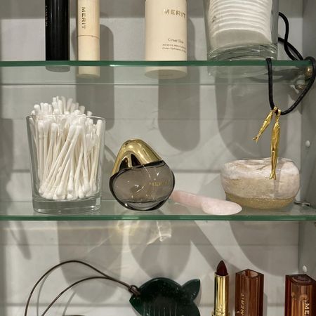 An image of Merit Retrospect, one of the most popular perfumes 2025, on a bathroom cabinet shelf