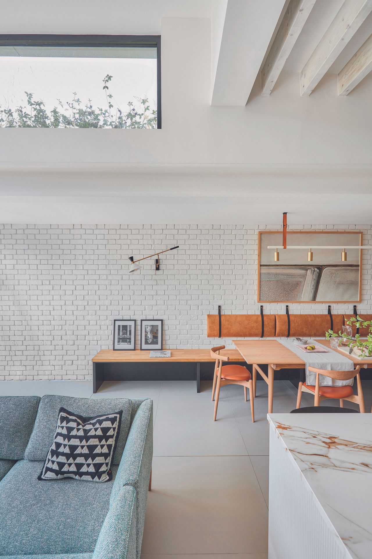 A view of the banquet dining seating in the open plan kitchen featuring a skylight