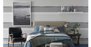Coastal style bedroom with blue horizontal stripe wallpaper