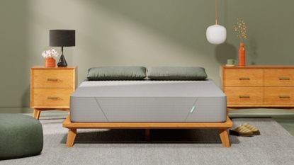 The Siena Memory Foam Mattress against a sage green wall, with two dressers either side.