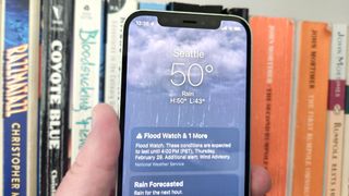 Weather app on an iPhone 12 running iOS 17 and showing a flood warning