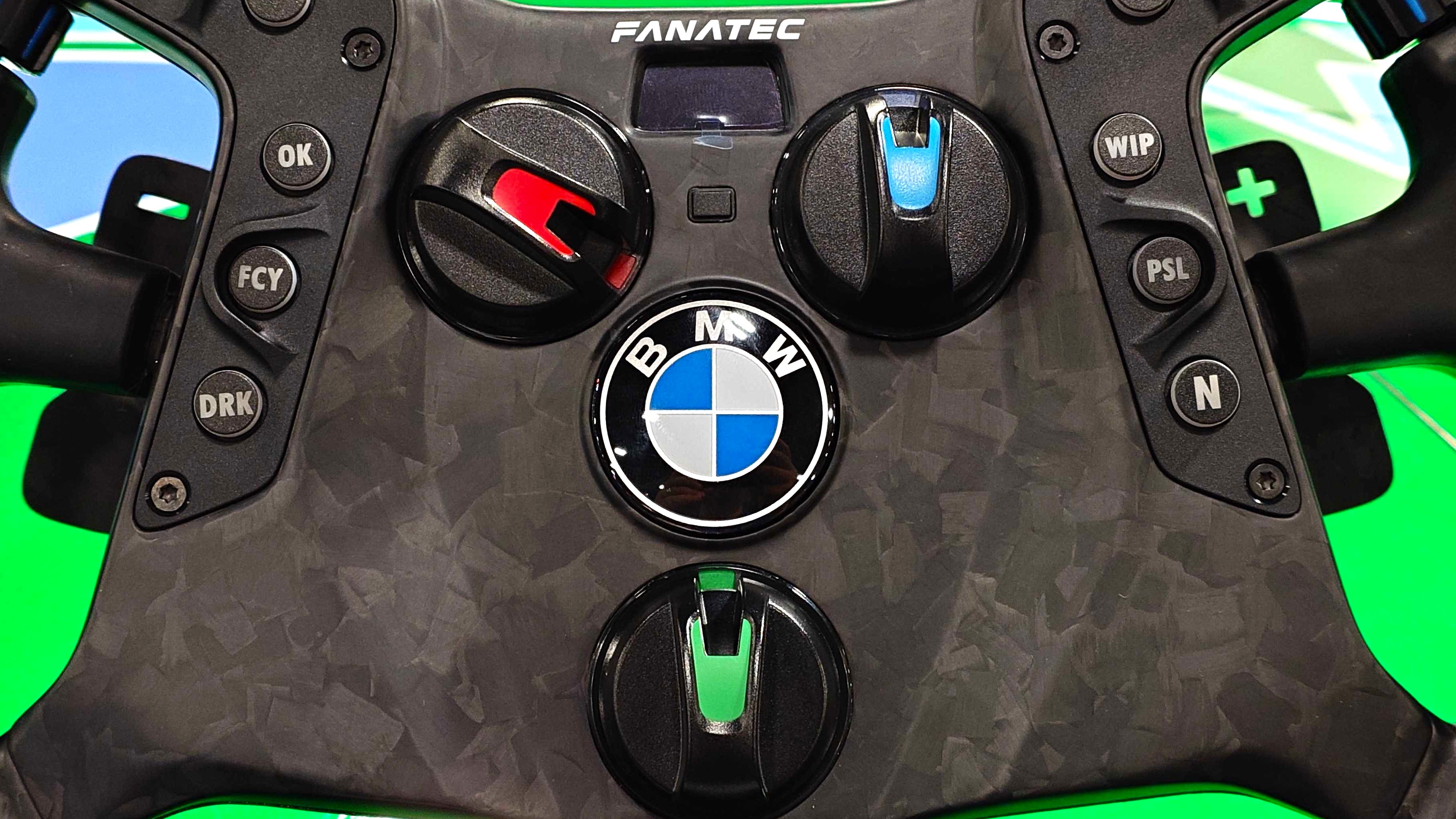 A close-up photo of the Fanatec Podium BMW M4 GT3 racing wheel on top of a BMW M4 GT3 race car.