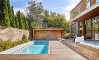 A backyard at Garden Circle House with natural colored decking and fence work