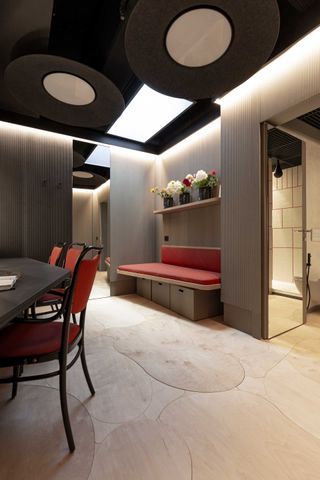 Changing rooms with light wooden floors and red seating