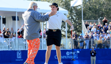 John Daly and John Daly II hug on the 18th green