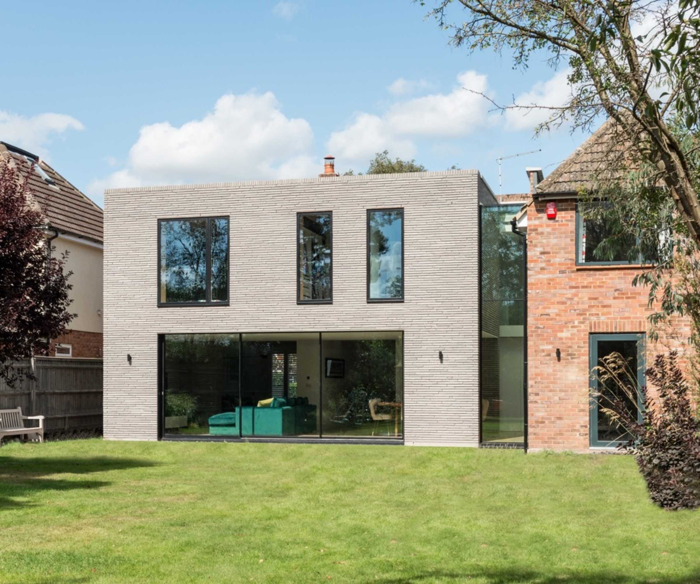 double storey modern extension with double storey glass link to home