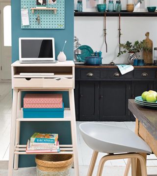 kitchen with teal blue wall and black cabinet