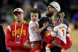 Harrison Butker #7 of the Kansas City Chiefs celebrates with his children after kicking the go ahead field goal to beat the Philadelphia Eagles in Super Bowl LVII at State Farm Stadium on February 12, 2023 in Glendale, Arizona.