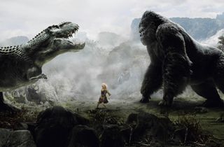 Naomi Watts as Ann Darrow stands between a dinosaur and King Kong as the two roar at each other in King Kong.