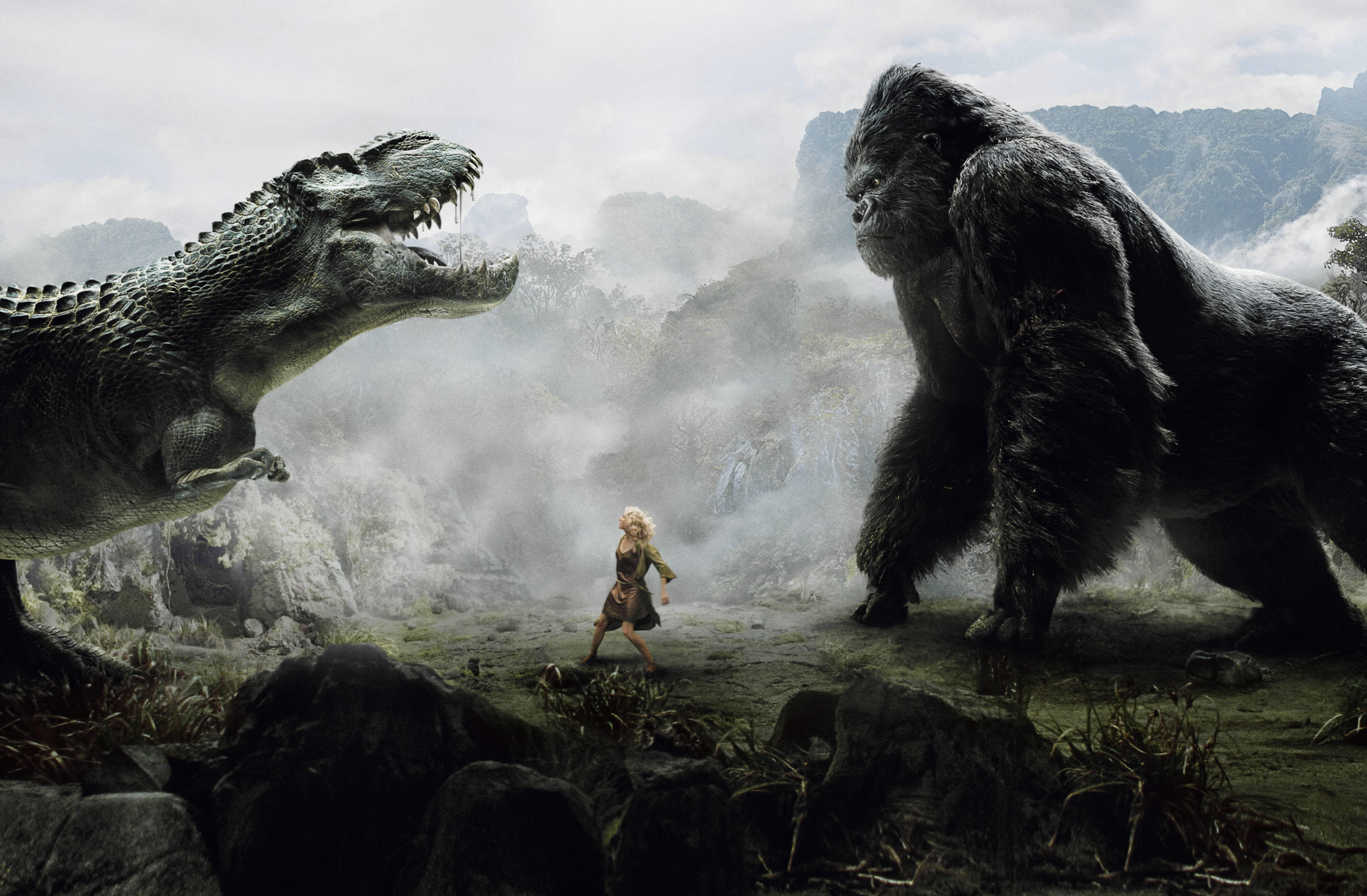 Naomi Watts como Ann Darrow se encuentra entre un dinosaurio y King Kong mientras los dos rugen el uno al otro en King Kong.