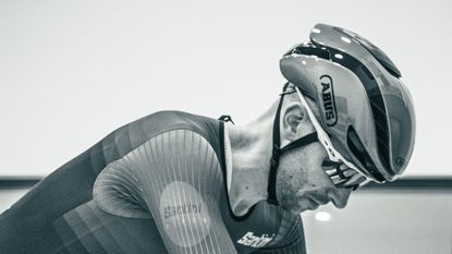 A close up of Tom wearing the Abus Gamechanger helmet while riding in the wind tunnel