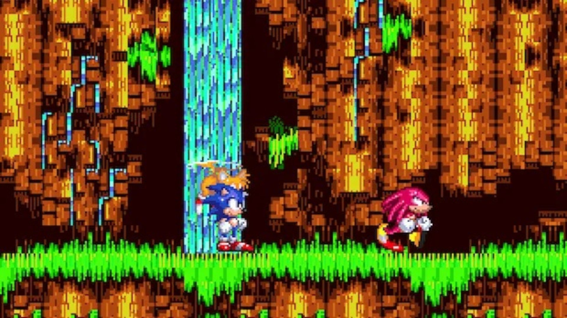 Sonic the Hedgehog 3 screenshot of Sonic and Tails standing on a grassy platform with a waterfall as Knuckles runs on ahead