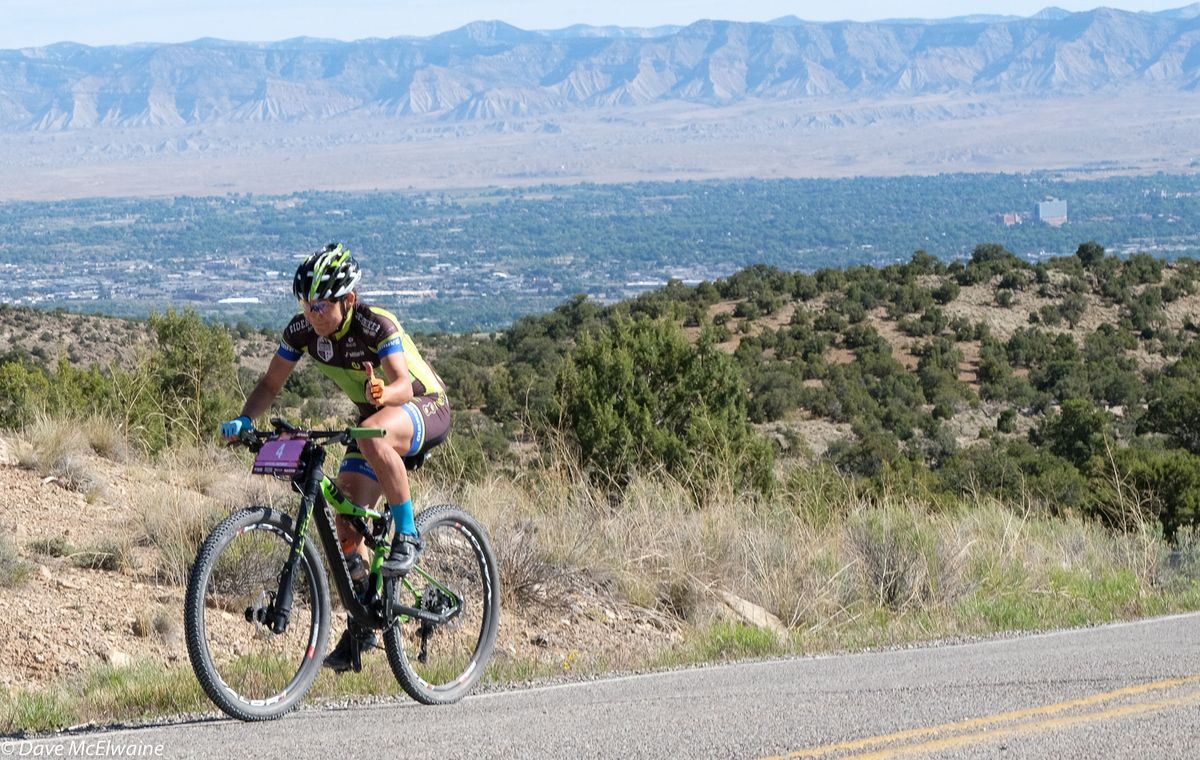 Crystal Anthony (Riverside Racing) on the road climb with Grand Junction in the background