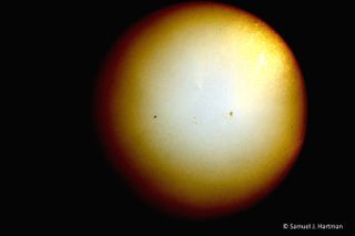 Hazy photo of Mercury transit across the sun