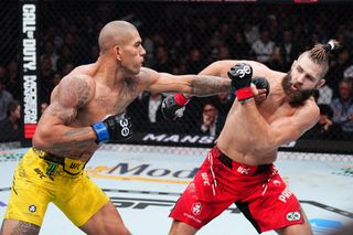 Alex Pereira of Brazil punches Jiri Prochazka of the Czech Republic in the UFC light heavyweight championship fight during the 2023 UFC 295 event