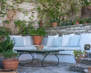 A garden seating area at a house in Corfu by Yellow London