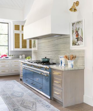 Neutral kitchen with large feature hood and blue range