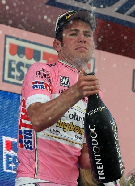 Mark Cavendish lets the champagne fly.