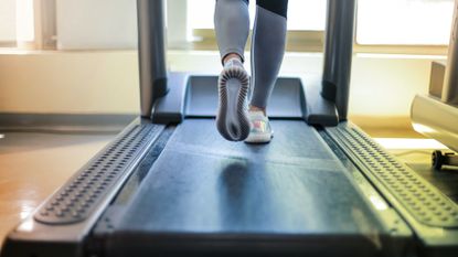 Best treadmill workout: Pictured here, the feet of a person running on a treadmill