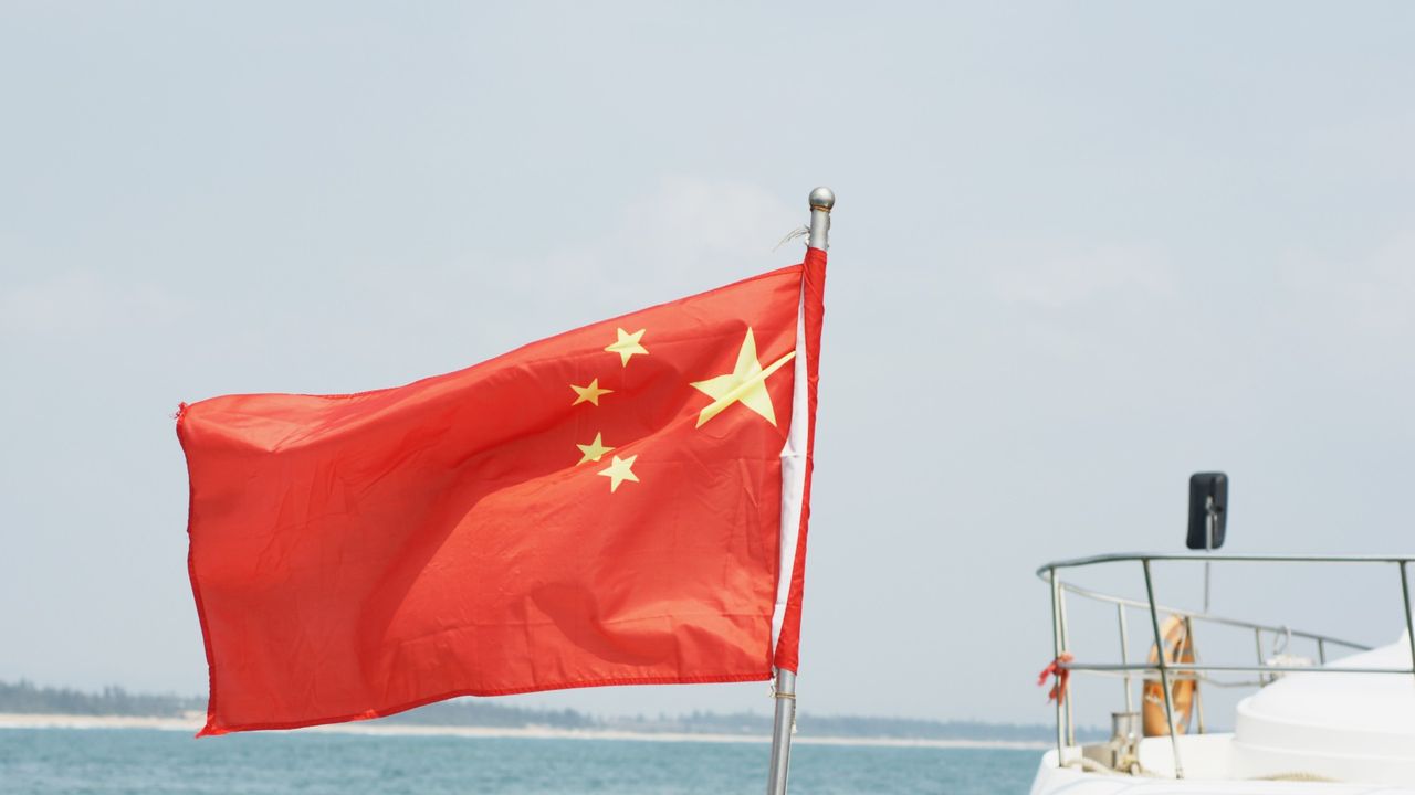 flag of the People&#039;s Republic of China waving on a boat