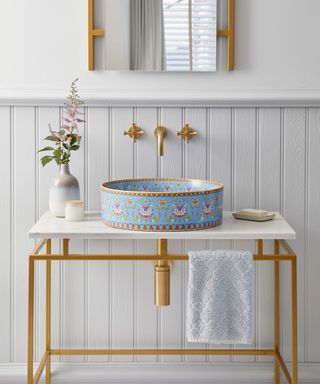Pretty decorative porcelain basin on washstand, with brass accents on fittings