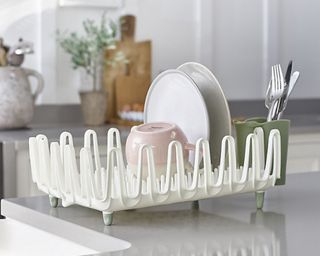 ILO Clam Shell Small Dish Drainer Rack, white, in grey and white kitchen with plates, cutlery and pink mug inside