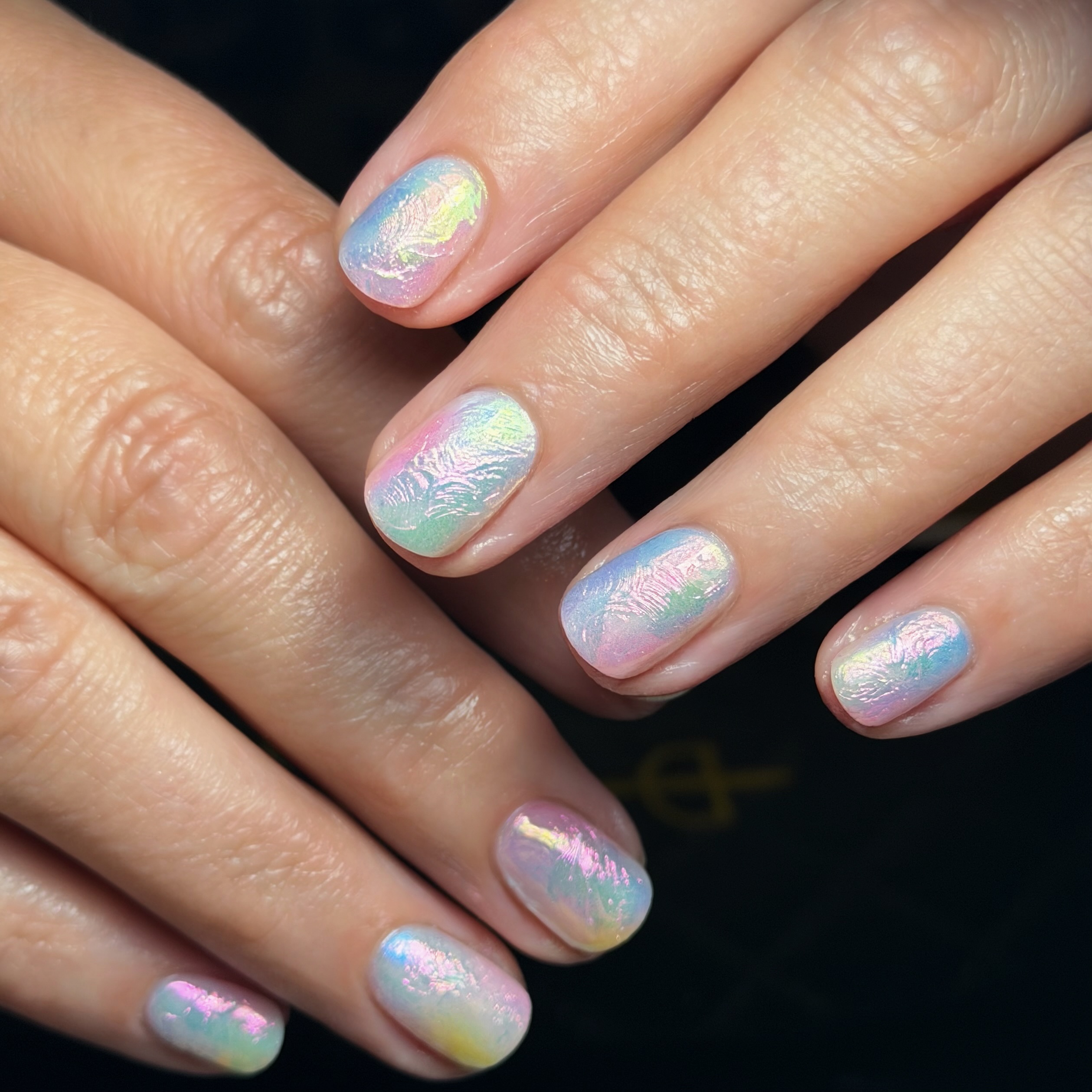Textured opalescent nails.