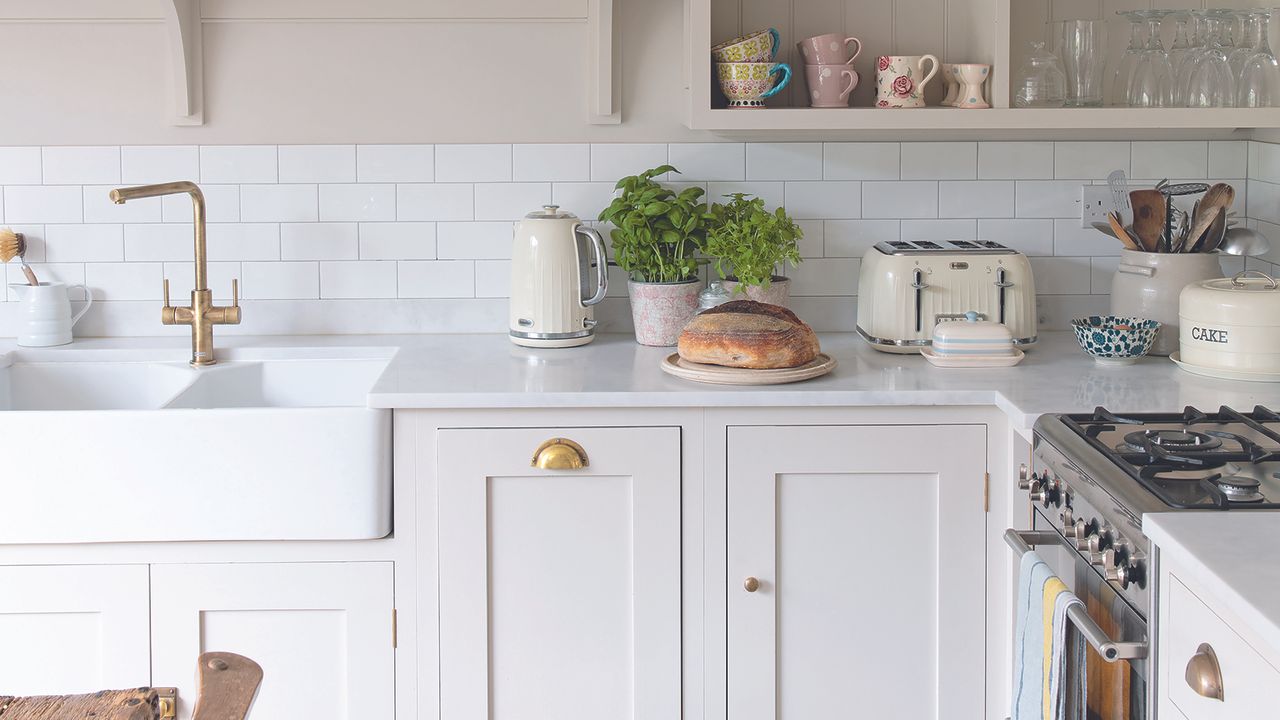 White Shaker kitchen with brass cupboard handles