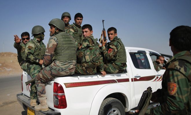 Iraqi troops pass through a checkpoint in Kalak, Iraq