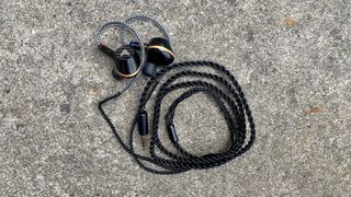 Audeze Euclid on a concrete surface, connected to their cable