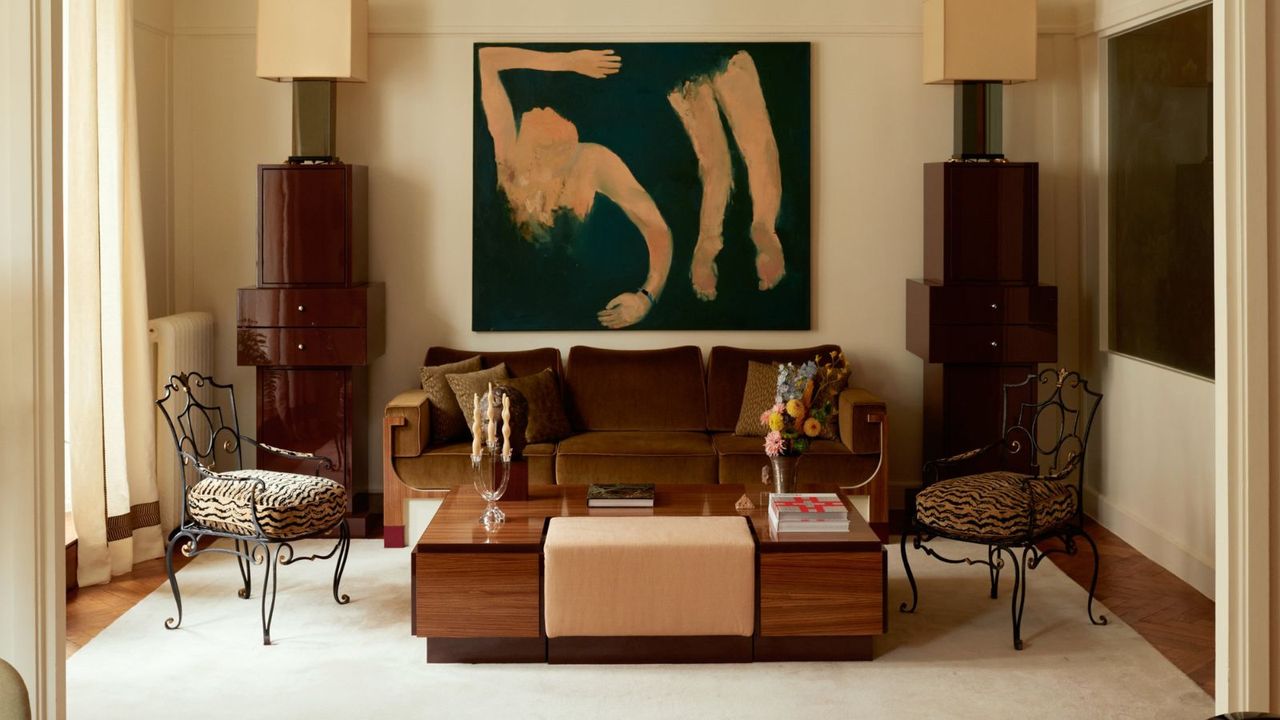 Art Deco living room with velvet sofa, lacquer wood table, iron chairs and abstract art