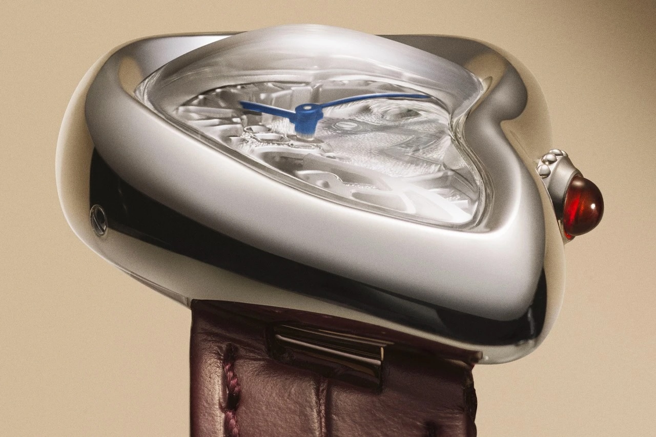 Close-up shot of an asymmetrical watch face on a brown leather strap