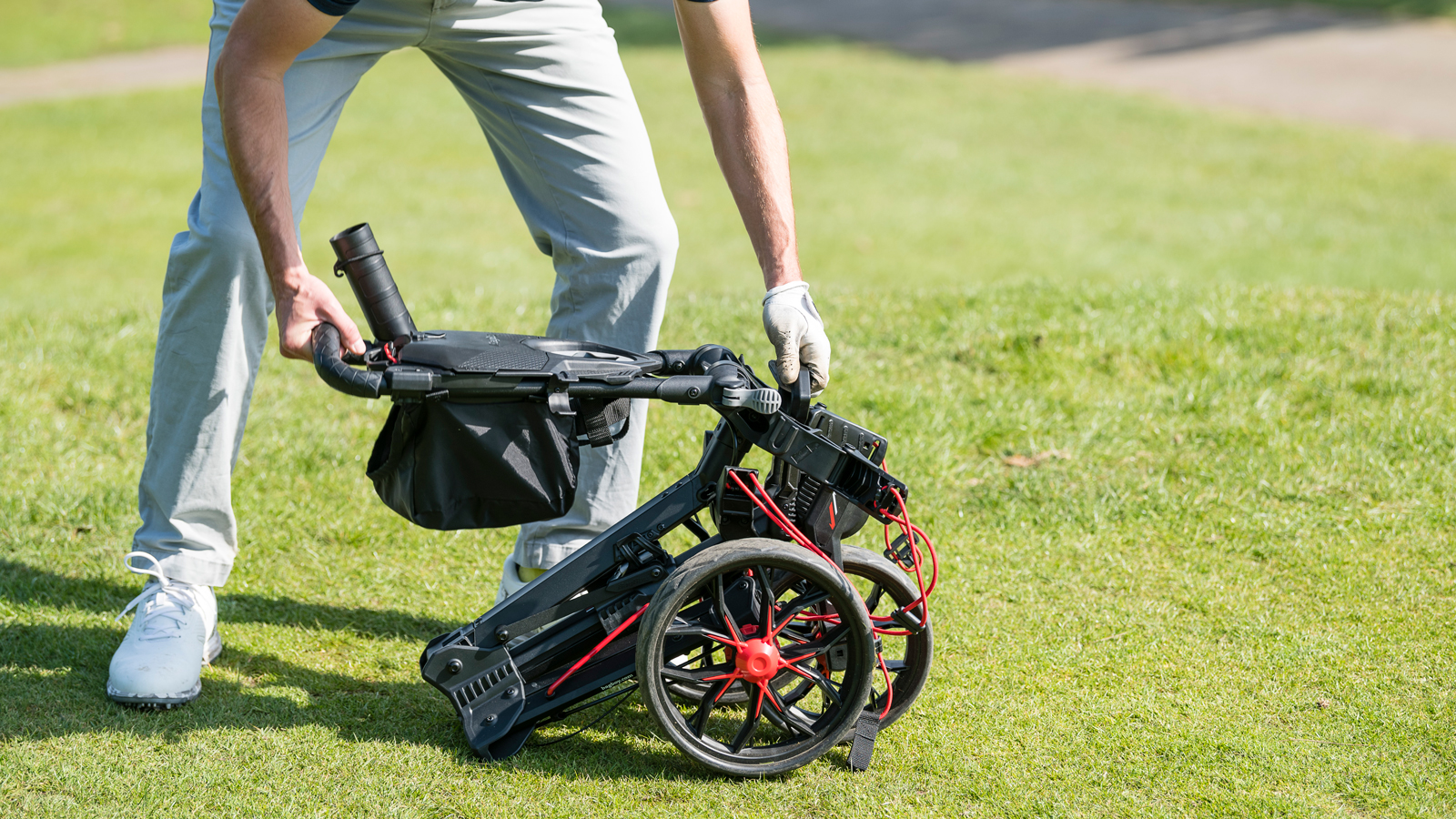 A golfer sets up the Bag Boy Nitron Push Cart