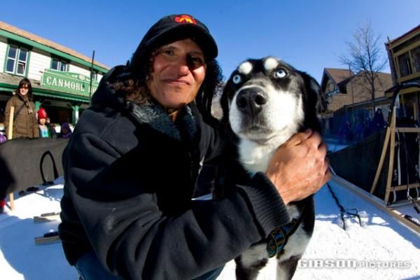 Tinker Juarez poses with a sled dog