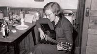 Connie Converse playing her acoustic guitar