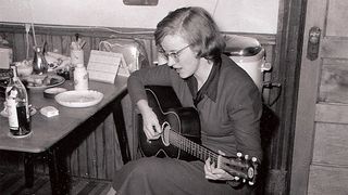 Connie Converse playing her acoustic guitar