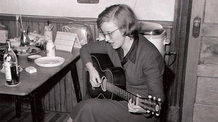 Connie Converse playing her acoustic guitar